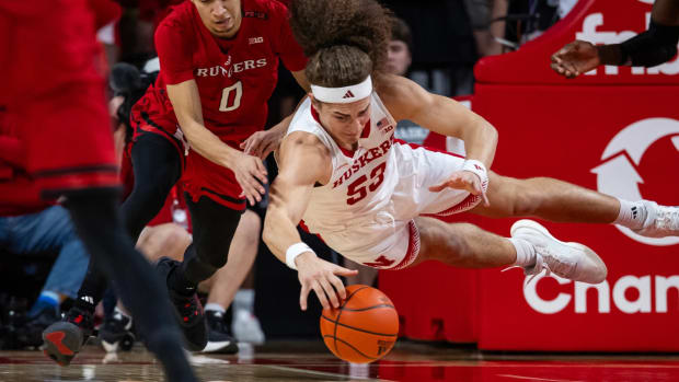 Nebraska's Josiah Allick dives for a loose ball against Rutgers' Derek Simpson on March 3, 2024, on Senior Day in Lincoln.